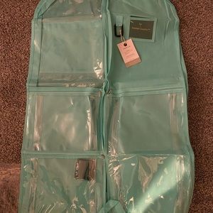 Teal garment bag with multiple pockets